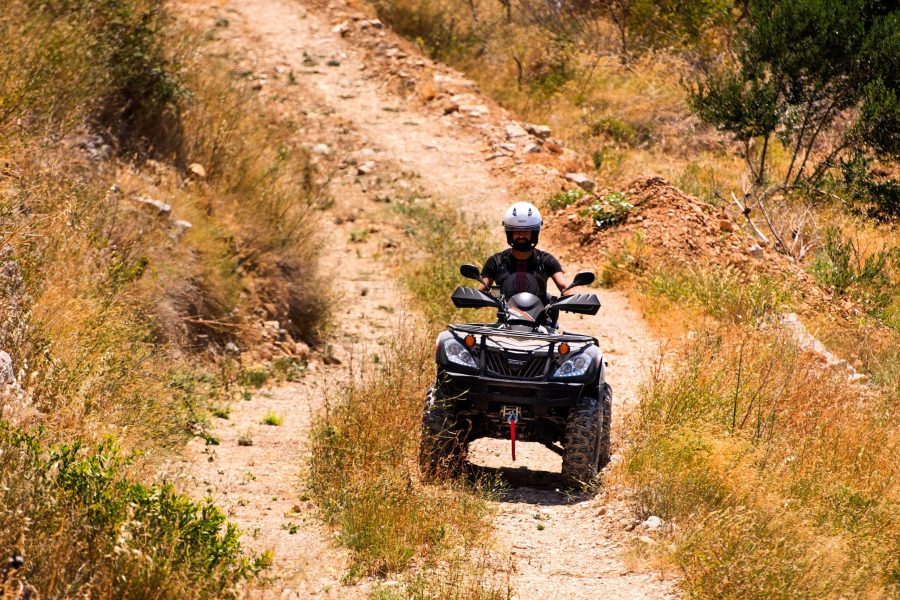 Single Quad On Safari Drives through pebble road