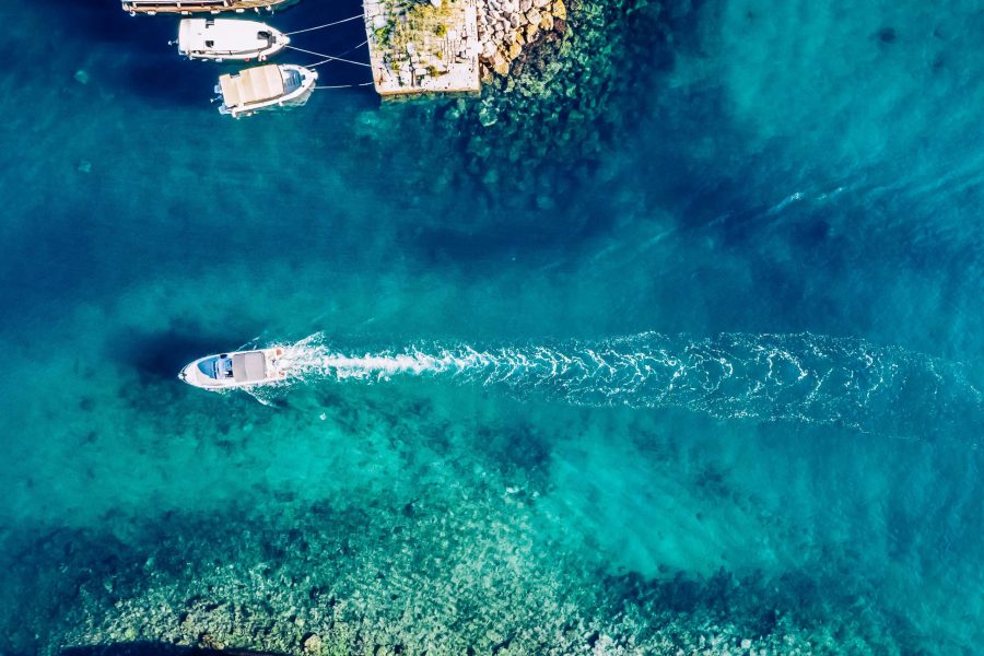 Speedboat Wizzes by colorful boats in a Marina in Dubrovnik, Croatia