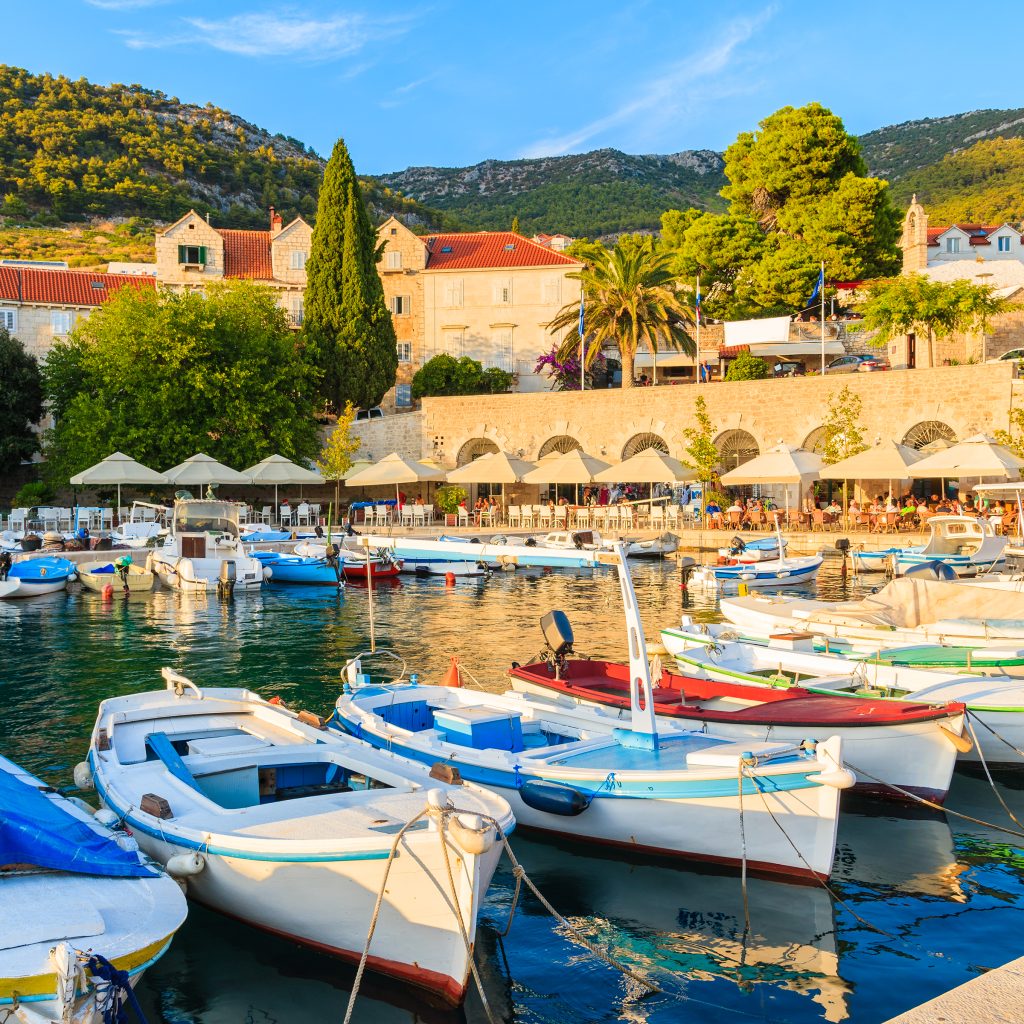 Traditional fishing boats in Bol port at sunset time, Brac island, Croatia