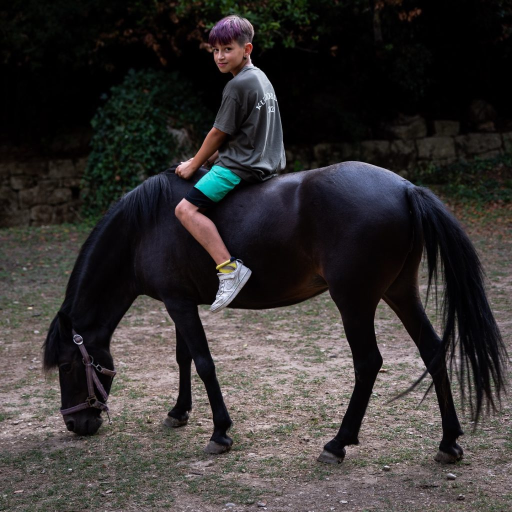 Boy Rides Black Horse At Radman Mills